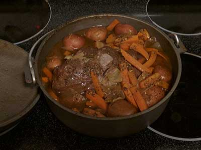 Dutch oven beef roast with carrots, onions and red potatoes